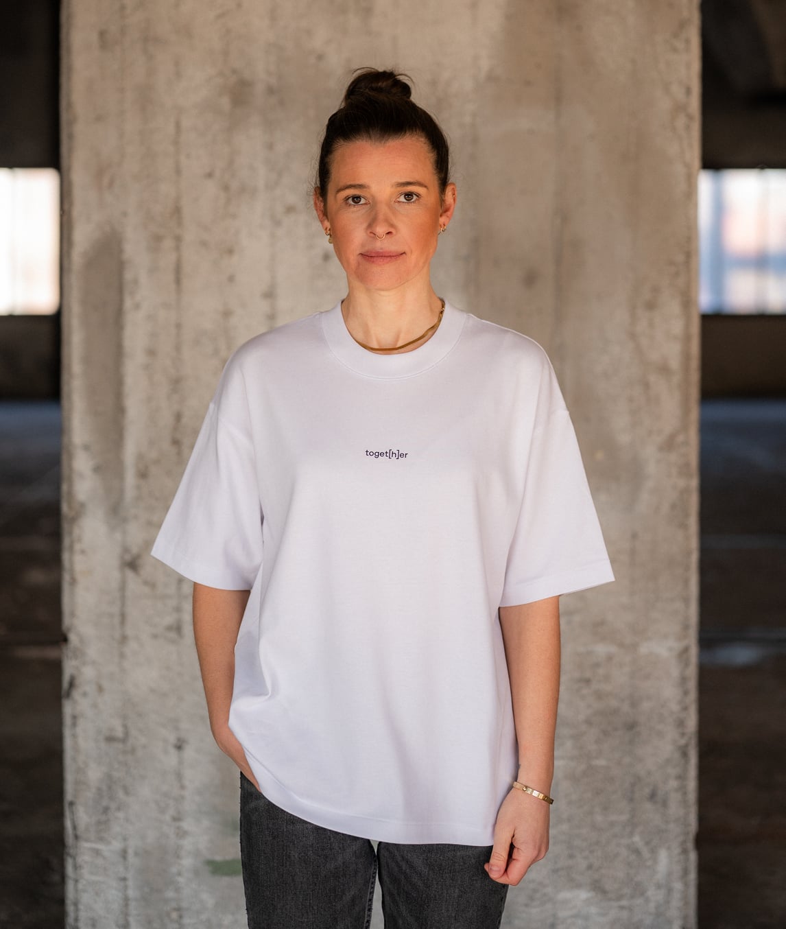 Frau trägt weißes T-Shirt mit Schriftzug „toget[h]er“ auf der Brust